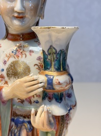 A Chinese famille rose candle holder in the shape of a court lady holding a 'Gu' vase, Qianlong