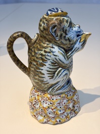 A pair of polychrome Dutch Delft monkey ewers and covers, 18th C.