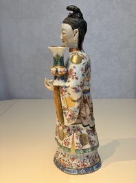 A Chinese famille rose candle holder in the shape of a court lady holding a 'Gu' vase, Qianlong