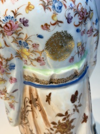 A Chinese famille rose candle holder in the shape of a court lady holding a 'Gu' vase, Qianlong
