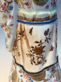 A Chinese famille rose candle holder in the shape of a court lady holding a 'Gu' vase, Qianlong