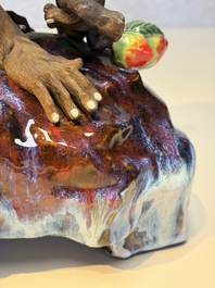 A Chinese polychrome-glazed Shiwan stoneware 'Monkey and Peach' group, signed, 20th C.