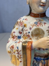 A Chinese famille rose candle holder in the shape of a court lady holding a 'Gu' vase, Qianlong
