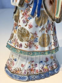 A Chinese famille rose candle holder in the shape of a court lady holding a 'Gu' vase, Qianlong