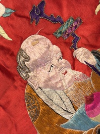 An extremely large Chinese red-ground embroidered silk 'Sanxing and Eight Immortals' panel, 19th C.