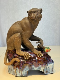 A Chinese polychrome-glazed Shiwan stoneware 'Monkey and Peach' group, signed, 20th C.