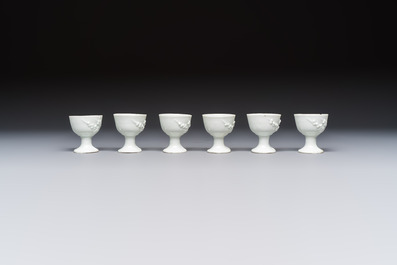 Four Chinese Dehua blanc de Chine figures of Guanyin and six wine cups, Kangxi and later