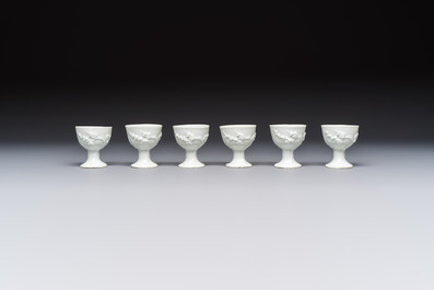 Four Chinese Dehua blanc de Chine figures of Guanyin and six wine cups, Kangxi and later