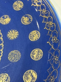 A large Chinese gilt-decorated powder-blue-ground 'Dragon' dish on a later wooden stand, Guangxu mark and of the period
