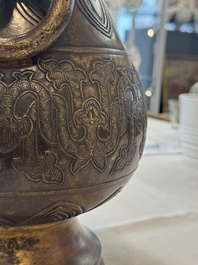 A fine and large Chinese archaistic gilt-bronze vase with handles, Ming