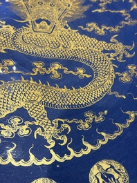 A large Chinese gilt-decorated powder-blue-ground 'Dragon' dish on a later wooden stand, Guangxu mark and of the period
