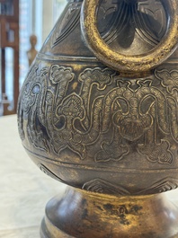 A fine and large Chinese archaistic gilt-bronze vase with handles, Ming