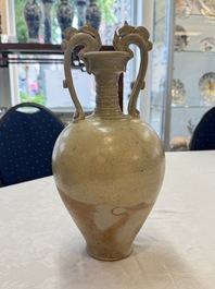 A Chinese straw-glazed pottery amphora with double dragon-shaped handles, Tang