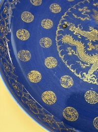 A large Chinese gilt-decorated powder-blue-ground 'Dragon' dish on a later wooden stand, Guangxu mark and of the period