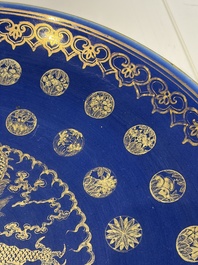 A large Chinese gilt-decorated powder-blue-ground 'Dragon' dish on a later wooden stand, Guangxu mark and of the period