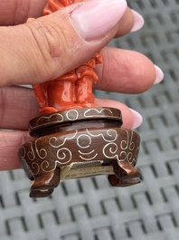 Three Chinese red coral carvings on wooden stands, 19/20th C.