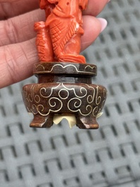 Three Chinese red coral carvings on wooden stands, 19/20th C.