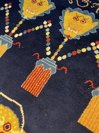 A Sino-Tibetan inscribed woollen 'Dragon' pillar carpet, 19th C.