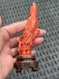 Three Chinese red coral carvings on wooden stands, 19/20th C.