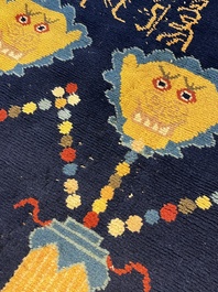 A Sino-Tibetan inscribed woollen 'Dragon' pillar carpet, 19th C.