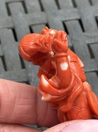 Three Chinese red coral carvings on wooden stands, 19/20th C.