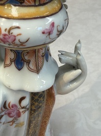 A Chinese famille rose candle holder in the shape of a court lady holding a 'Gu' vase, Qianlong