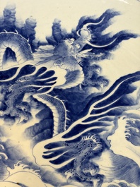 A massive Japanese blue and white 'Dragon among Sea Waves' dish, probably Arita, Meiji, 19th C.