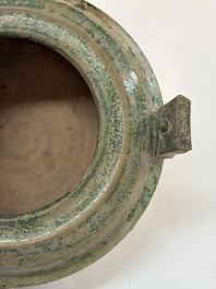 A Chinese green-glazed pottery ritual tripod food vessel with handles, 'Ding 鼎', Han