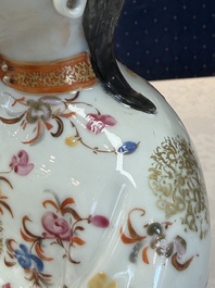 A Chinese famille rose candle holder in the shape of a court lady holding a 'Gu' vase, Qianlong