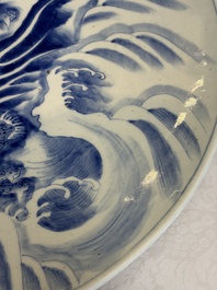 A massive Japanese blue and white 'Dragon among Sea Waves' dish, probably Arita, Meiji, 19th C.