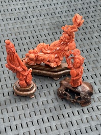 Three Chinese red coral carvings on wooden stands, 19/20th C.