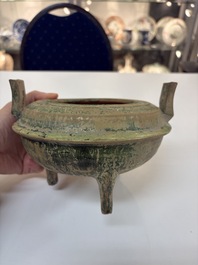 A Chinese green-glazed pottery ritual tripod food vessel with handles, 'Ding 鼎', Han