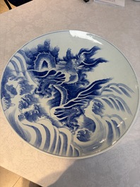 A massive Japanese blue and white 'Dragon among Sea Waves' dish, probably Arita, Meiji, 19th C.