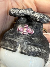 A Chinese famille rose candle holder in the shape of a court lady holding a 'Gu' vase, Qianlong