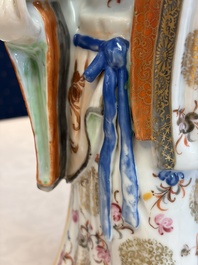 A Chinese famille rose candle holder in the shape of a court lady holding a 'Gu' vase, Qianlong