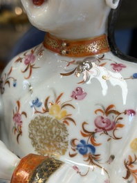 A Chinese famille rose candle holder in the shape of a court lady holding a 'Gu' vase, Qianlong