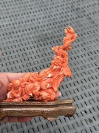 Three Chinese red coral carvings on wooden stands, 19/20th C.