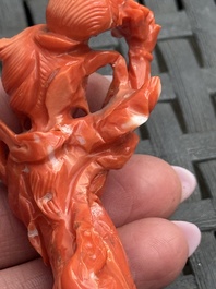 Three Chinese red coral carvings on wooden stands, 19/20th C.