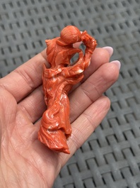 Three Chinese red coral carvings on wooden stands, 19/20th C.