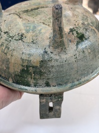 A Chinese green-glazed pottery ritual tripod food vessel with handles, 'Ding 鼎', Han