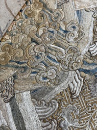 A Chinese cream-ground embroidered silk panel with bats, floral scrolls, waves and rockwork, 19th C.