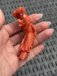 Three Chinese red coral carvings on wooden stands, 19/20th C.