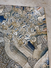 A Chinese cream-ground embroidered silk panel with bats, floral scrolls, waves and rockwork, 19th C.