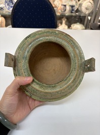 A Chinese green-glazed pottery ritual tripod food vessel with handles, 'Ding 鼎', Han