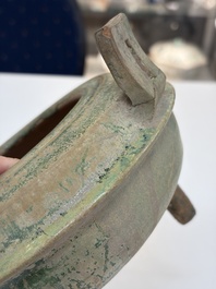 A Chinese green-glazed pottery ritual tripod food vessel with handles, 'Ding 鼎', Han