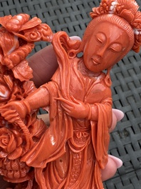A Chinese carved red coral 'Goddess and Boys' group on a wooden stand, 19/20th C.