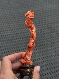 Three Chinese red coral carvings on wooden stands, 19/20th C.