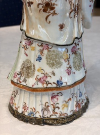 A Chinese famille rose candle holder in the shape of a court lady holding a 'Gu' vase, Qianlong