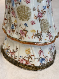 A Chinese famille rose candle holder in the shape of a court lady holding a 'Gu' vase, Qianlong