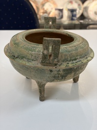 A Chinese green-glazed pottery ritual tripod food vessel with handles, 'Ding 鼎', Han